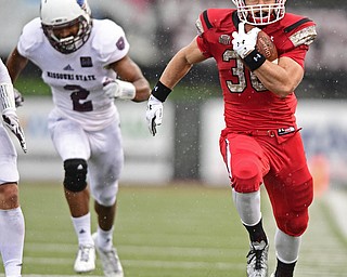 YOUNGSTOWN, OHIO - NOVEMBER 18, 2017: Youngstown State's Joe Alessi runs down the sideline away from Missouri State's Darius Joseph and into the end zone to score a touchdown during the first half of Saturday afternoons game at Stambaugh Stadium. Youngstown State won 38-10. DAVID DERMER | THE VINDICATOR