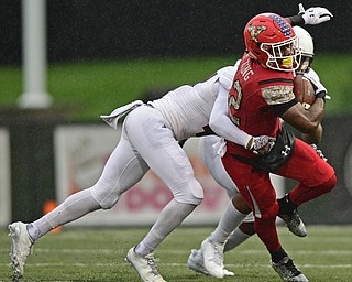 YOUNGSTOWN, OHIO - NOVEMBER 18, 2017: Youngstown State's Samuel St. Surin runs with the football while being hit by Missouri State's Cam Carter and Angelo Garbutt during the second half of Saturday afternoons game at Stambaugh Stadium. Youngstown State won 38-10. DAVID DERMER | THE VINDICATOR