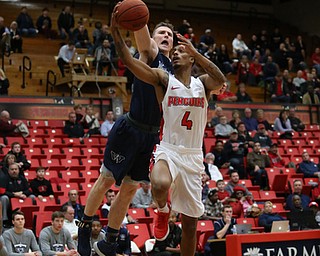 Youngstown State guard Jaylen Benton (4) goes up for a layup against Westminister College forward JarretÊVrabel (15) during the first half as Westminister College takes on Youngstown State in a NCAA basketball game, Tuesday, Nov. 21, 2017, at the Beeghly Center in Youngstown. YSU won 91-83...(Nikos Frazier | The Vindicator)..