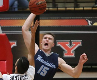 Westminister College forward JarretÊVrabel (15) spikes the ball away from Youngstown State guard Francisco Santiago (23) during the second half as Westminister College takes on Youngstown State in a NCAA basketball game, Tuesday, Nov. 21, 2017, at the Beeghly Center in Youngstown. YSU won 91-83...(Nikos Frazier | The Vindicator)..
