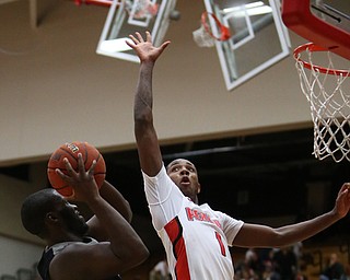 Westminister College forward DeontayÊScott (42) goes up for a layup as Youngstown State guard Braun Hartfield (1) goes up to block his shot during the second half as Westminister College takes on Youngstown State in a NCAA basketball game, Tuesday, Nov. 21, 2017, at the Beeghly Center in Youngstown. YSU won 91-83...(Nikos Frazier | The Vindicator)..