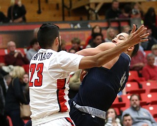 Westminister College guard CameronÊKane-Johnson (4) falls down while going up for a layup against Youngstown State guard Francisco Santiago (23) during the second half as Westminister College takes on Youngstown State in a NCAA basketball game, Tuesday, Nov. 21, 2017, at the Beeghly Center in Youngstown. YSU won 91-83...(Nikos Frazier | The Vindicator)..