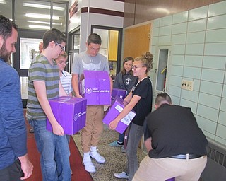 Neighbors | Zack Shively.Students from Scott Lenhart's eighth-grade class move boxes of books to his classroom on Oct. 4. Pictured are, clockwise from left, John Stanko of Boardman Subaru, students William Parker, Justin Yocum, Joseph Sferra, Olivia Garland and Victoria Colovos and Donnie Nameth from Boardman Subaru.