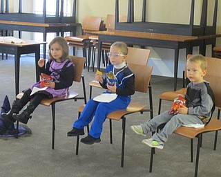 Neighbors | Zack Shively.The children enjoyed a snack at the end of the Poland library's Halloween party on Oct. 14. They had their choice of different types of chips.