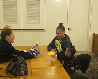 Neighbors | Zack Shively.One station at "Playtime at Your Library" at the Austintown library had hand puppets for children and parents to create a story using the puppets.