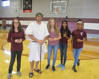Neighbors | Zack Shively.Students gave olive seeds to their "science god" from Mount Olympus, portrayed by eighth-grade science teacher Scott Lenhart. Pictured are, from left, Abbey Tatar, Lenhart, Sarah Merzic, Mahum Imran and Kennedy Pickard.
