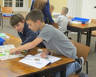 Neighbors | Zack Shively.The Poland library hosted a Lego WeDo Robots event on Oct. 17. The children at the event worked together to make their robots. Pictured are, from left, Max and Jack grabbing pieces that they needed to build their machine.