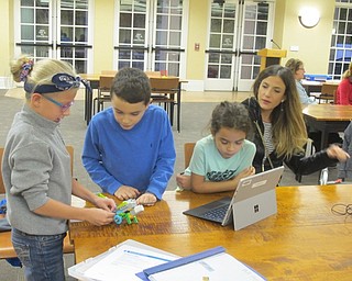 Neighbors | Zack Shively.The children, from left, Lily, Anthony and Christina, changed different things on their robot to make it work properly. Part of the objective of the Lego WeDo Robots event is to get the childen to troubleshoot and think critically about what they are doing.