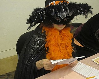 Neighbors | Zack Shively.The participants of the murder mystery party received a newspaper with clues spread throughout. Pictured, Valerie Lemme looked at the front page of the newspaper detailing the murder and giving a map of the neighborhood in which it happened.