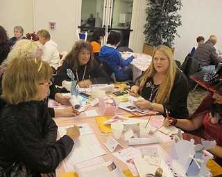 Neighbors | Zack Shively.Organizer Lindsay Platt gave the "detectives" at the library a set of 20 clues for their final set of clues for the murder mystery. Pictured, a group read the clues and tried to sort out who murdered the victim, the weapon the murderer used to do the crime and the motive for the crime.