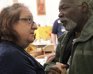 William D. Lewis the Vindicator   Darrell McLendon of Youngstown shares a moment with Jackie Rogenski during annual free community Thanksgiving dinner at First Presbyterian Church in Youngstown Thursday 11-16-17.Rogenski is a member of the church and was volunteering at the event.