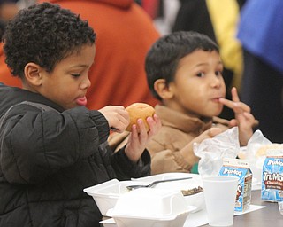 William D. Lewis the Vindicator   Brothers Richard, 7, left, and Juwan Ditosto, 6, chow down during annual free community Thanksgiving dinner at First Presbyterian Church in Youngstown Thursday 11-16-17.They are sons of Jessica Bell of Youngstown.