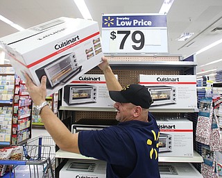 POSED PHOTO..Walmart employee Julio Argont stocks the shelves with a Cuisinart Toaster Oven, Thursday, Nov. 16, 2017, at the Walmart Supercenter in Boardman. The Cuisinart brand is new to Walmart this season...(Nikos Frazier | The Vindicator)
