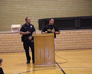Neighbors | Abby Slanker.Canfield Schools Resource Officer Steve Garstka (left) and Canfield Police Department Detective Brian McGivern (right) spoke to Canfield Village Middle School fifth-graders during the school’s DARE Program graduation assembly on Nov. 6.