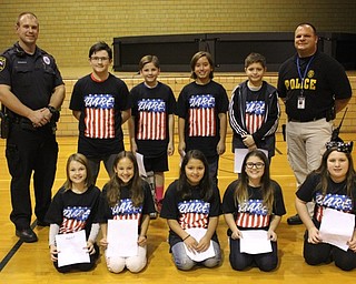 Neighbors | Abby Slanker.Nine Canfield Village Middle School fifth-graders were featured at the school’s DARE Program graduation assembly as they read essays they had written which answered the question, "Why do I think DARE is important?" on Nov. 6. Canfield Schools Resource Officer Steve Garstka (back, left) and Canfield Police Department Detective Brian McGivern (back, right) spoke to the students at the assembly.