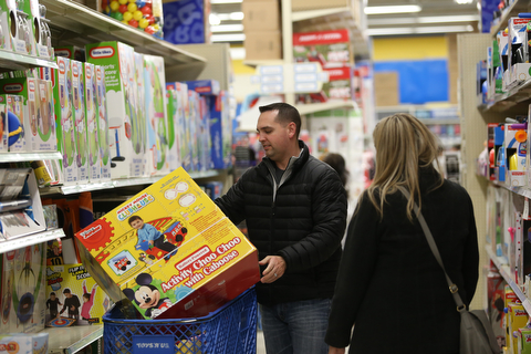 Matt and Ashley Stellato of North Lima load their cart with a Disney Activity Choo Choo during Black Friday shopping, Thursday, Nov. 23, 2017, at the Toys R Us in Boardman...(Nikos Frazier | The Vindicator)