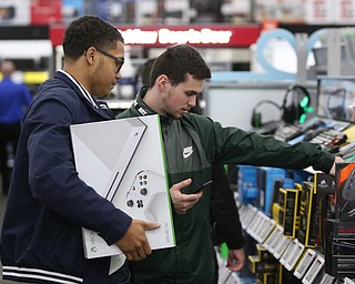 Andrew Donley(right) of Boardman and Brylen Caddiell of Niles look at gaming accessories during Black Friday shopping, Thursday, Nov. 23, 2017, at the Best Buy in Boardman...(Nikos Frazier | The Vindicator)