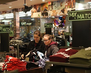Megan Grimmett(right) of Aurora and Gabi Chamberlain of Columbiana look though a pile of t-shirts during Black Friday shopping, Thursday, Nov. 23, 2017, at Tilly's in Southern Park Mall in Boardman...(Nikos Frazier | The Vindicator)