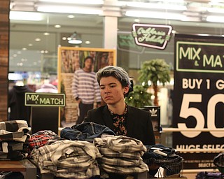 Sayaka Kato of Mason, Ohio, looks through a pile of flannels during Black Friday shopping, Thursday, Nov. 23, 2017, at STORE in Southern Park Mall in Boardman...(Nikos Frazier | The Vindicator)