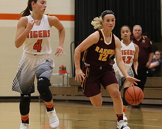 South Range's Bree Kohler (12) charges towards the net as Howland's Mackenzie Maze (4) closes in during the first quarter of the Toni Ross Spirit Foundation basketball tournament, Saturday, Nov. 25, 2017, at Howland High School in Howland. South Range won 55-51...(Nikos Frazier | The Vindicator)..