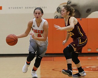 Howland's Mackenzie Maze (4) dribbles towards the basket as South Range's Brooke Sauerwein (20) tries to screen during the second quarter of the Toni Ross Spirit Foundation basketball tournament, Saturday, Nov. 25, 2017, at Howland High School in Howland. South Range won 55-51...(Nikos Frazier | The Vindicator)..
