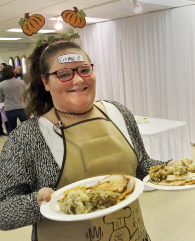 William D. Lewis The Vindicator Emma Garon, 12, of Hubbard serves up Thanksgiving Dinners during a Sunday 11-19-17 community dinner at St Patrick Church in Hubbard.