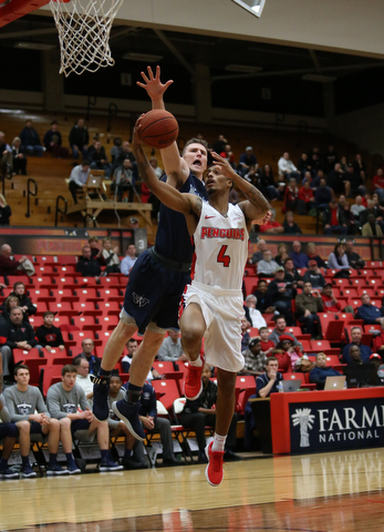 Youngstown State guard Jaylen Benton (4) goes up for a layup against Westminster College forward JarretÊVrabel (15) during the first half as Westminster College takes on Youngstown State in a NCAA basketball game, Tuesday, Nov. 21, 2017, at the Beeghly Center in Youngstown. YSU won 91-83...(Nikos Frazier | The Vindicator)..