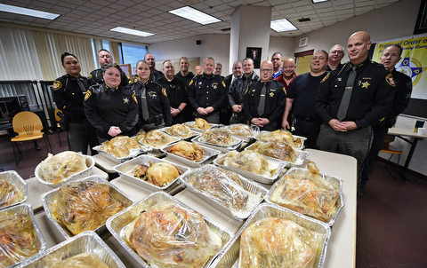 YOUNGSTOWN, OHIO - NOVEMBER 21, 2017: Mahoning County Sheriff that helps prepare and cook turkeys stand near their work inside of the Mahoning County Jail on Tuesday morning. DAVID DERMER | THE VINDICATOR