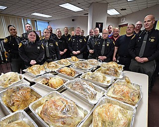YOUNGSTOWN, OHIO - NOVEMBER 21, 2017: Mahoning County Sheriff that helps prepare and cook turkeys stand near their work inside of the Mahoning County Jail on Tuesday morning. DAVID DERMER | THE VINDICATOR