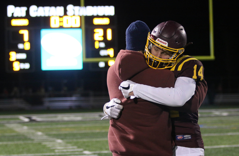 South Range's Aniello Buzzacco (14) gets consoled by his father David Buzzacco after the Raiders loss to Eastwood 21-7 on Friday night .Dustin Livesay |  The Vindicator  11/24/17  Strongsville.