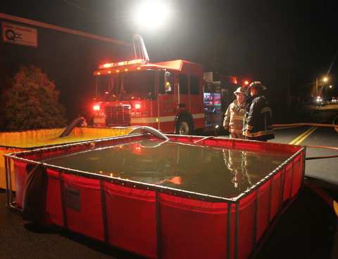 William D. Lewis The Vindicator  Firefighters from several Columbiana County departments respond to a fire at the former Salem China facilty on S. Broadway in Salem Tuesday Nov 28, 2017. They are shown here setting up portable water tanks to provide water to fight the fighter. Smoke from hte fire could be seen from Austintown.