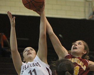William d. Lewis the Vindicator Boardman's Alicia Saxton(11) and Mooney's Camden Hergenrother(14) go for a rebound during 11292017 action at Boardman.