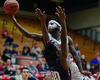 YOUNGSTOWN, OHIO - NOVEMBER 29, 2017: Youngstown State's Jeremiah Ferguson goes to the basket against Robert Morris's Koby Thomas during the second half of their game Wednesday night at Beeghley Center. Robert Morris won 81-74. DAVID DERMER | THE VINDICATOR