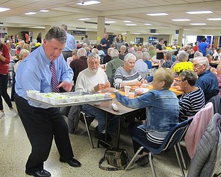 Neighbors | Zack Shively.Austintown Fitch High School had a Senior Dinner on Oct. 23 to give back the senior citizens in the Austintown community. Pictured is principal Chris Berni handing salads to the seniors.