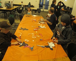 Neighbors | Zack Shively.Children made two crafts at the Austintown library's "Halloween Family Story Time." They made mummies by gluing tissue paper to a cut out. They also received treat bag that they decorated with stickers and drew on with crayons.