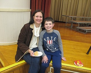 Neighbors | Zack Shively.After the concert, the children and their guests had a snack to eat. The PTA helped organize the event and brought the snacks for the students and guests. Pictured, Robin and Joseph Bertin enjoyed their snacks after the concert.