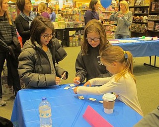 Neighbors | Zack Shively.The Dobbins Elementary School's PTO organized the book fair at Barnes and Noble. They placed a number of play stations throughout the store, such as the mix and match game pictured. The students playing the game are, from left, Arianna Schiavone, Lila Gordon, and Macey Kapics.
