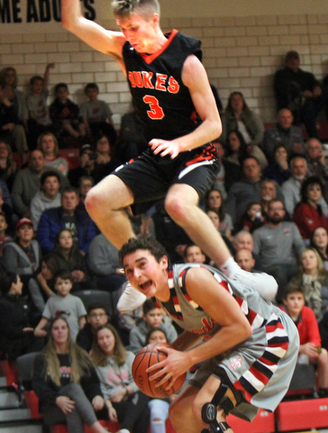 William D Lewis the vindicator Canfield's Ben Shapiro(3) keeps control of the ball as  Marlingtons Michael Huberty(3) flies over him during 11302017 action at Canfield.
