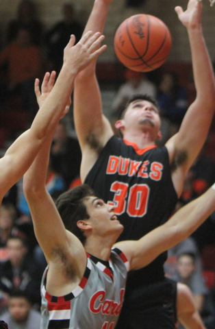 William D Leiws the vindicator Canfield's Spencer Woolley(11) pulls  down a rebound past Marlingtons Austin Brady(30) during 11302017 action at Canfield.
