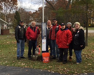 AMVETS Post 44 of Struthers celebrated the Marine Corps’ 242nd birthday by presenting and installing a flagpole and United States flag to Marine Julianne Buckshaw of Boardman for her yard. Participating members of the post, from left, are Tony Crespo, JP Brown III, Chuck Shaso, Shane Barnes, Ryan Brown, Angela Nerone and Jennifer Baun.