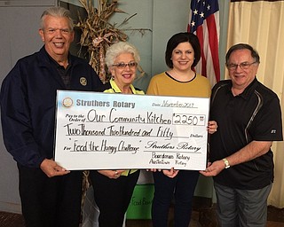 Local Rotary clubs recently presented a donation of $2,250 to Skip Barone, founder of Our Community Kitchen. Mary Ann Morell helped form the Feed the Hungry Challenge for Rotary District 6650. Struthers, Austintown and Boardman Rotary clubs joined together in the project. The kitchen serves breakfast and lunch to approximately 250 people daily and prepares take-home lunches. Attending the Struthers Rotary Club meeting for the presentation, from left, were Bruce Laraway, Austintown Rotary president; Mary Ann Morell, rotarian; Jennifer Johnson, Struthers Rotary president; and Skip Barone, founder of Our Community Kitchen. Mason Shattuck is the Boardman Rotary president.
