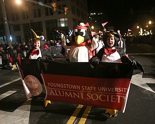 Members of the YSU Alumni Society walk with Pete the Penguin during the annual Youngstown Christmas Parade and Tree lighting, Friday, Dec. 1, 2017, in downtown Youngstown...(Nikos Frazier | The Vindicator)