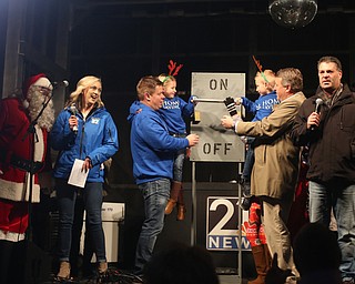 Reagan(7) and Cole(5) Toots help flip the switch to ignite the tree during the annual Youngstown Christmas Parade and Tree lighting, Friday, Dec. 1, 2017, in downtown Youngstown...(Nikos Frazier | The Vindicator)