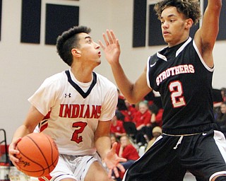 William D. Lewis Girard's Austin Claussell(2) drives around StruthersTyrese Hawkins(2)during 12012017 action at Girard.