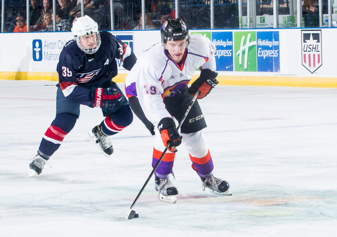 Scott R. Galvin | The Vindicator.Youngstown Phantoms right wing Chase Gresock (19) skates the puck to the goal past USA NTDP's Case McCarthy during the second period at the Covelli Centre on Friday night.