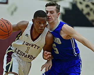 LIBERTY, OHIO - DECEMBER 1, 2017: Liberty's Dra Rushton, left, drive son Poland's Mike Masucci during the first half of their game, Friday night at Liberty High School. DAVID DERMER | THE VINDICATOR