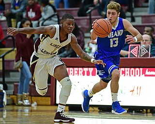 LIBERTY, OHIO - DECEMBER 1, 2017: Poland's Brandon Barringer dribbles ahead of Liberty's Dra Rushton during the first half of their game, Friday night at Liberty High School. DAVID DERMER | THE VINDICATOR