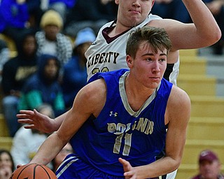 LIBERTY, OHIO - DECEMBER 1, 2017: Poland's Colin Todd drives under Liberty's Derek Gilcher during the first half of their game, Friday night at Liberty High School. DAVID DERMER | THE VINDICATOR