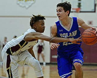 LIBERTY, OHIO - DECEMBER 1, 2017: Poland's Michael Cougras protects the ball from Liberty's Jae' Shaun Perel during the second half of their game, Friday night at Liberty High School. DAVID DERMER | THE VINDICATOR