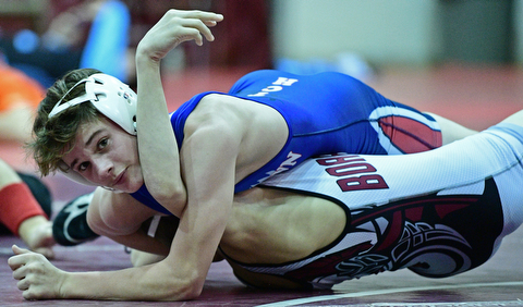 BOARDMAN, OHIO - DECEMBER 3, 2017: Fitch's Colin Roberts looks toward the clock while working to attempt to pin Boardman's Sam DeJoseph during their 106lb bout, Saturday morning at Boardman High School. DAVID DERMER | THE VINDICATOR
